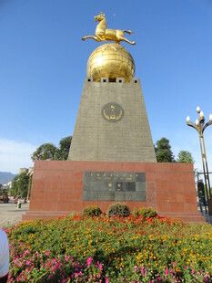 金色雕塑矗立多彩花丛中