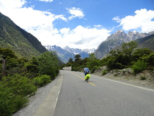 公路骑行者穿行于山间美景