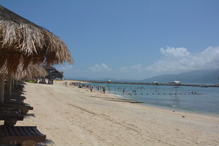 海滨茅草屋下的宁静沙滩