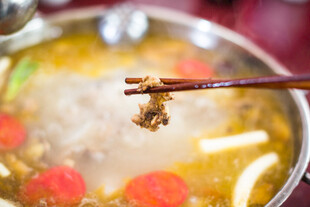 筷子夹起锅中美味食材