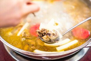 热气腾腾的美味火锅舀汤瞬间