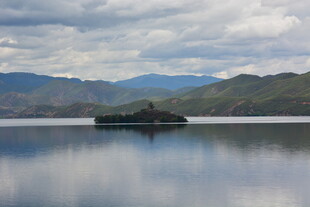 宁静湖面中的孤岛与远山