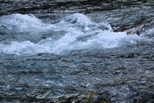 山间溪流涌动的白色浪花