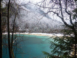冬日山林中的幽蓝湖水
