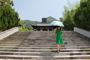 绿衣女子漫步石阶美景处
