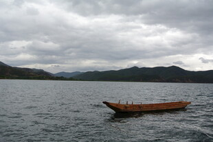 孤舟泛于山水云雾间