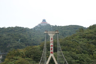 山间吊桥与远处宝塔景观