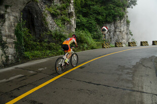 公路骑行者穿行山间隧道