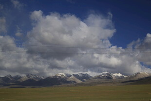 草原上的壮丽云景与雪山