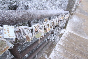 覆雪栏杆上的多彩许愿牌