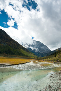 山间清澈溪流与壮丽雪山