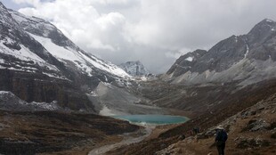雪山下的徒步者与湖泊