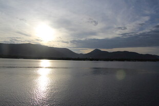 夕阳下平静湖面与远山
