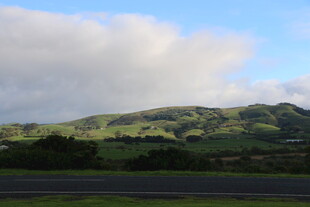 公路旁的翠绿山峦与蓝天