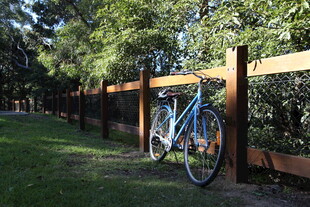 户外木栅栏旁的蓝色自行车