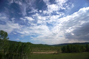 山间蓝天白云下的开阔景致