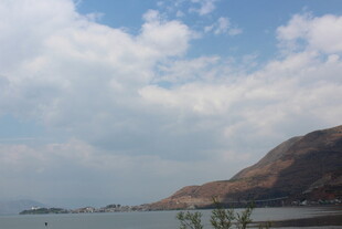 湖畔山峦与蓝天白云美景