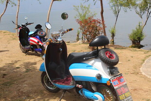 湖畔停放的多彩电动摩托车