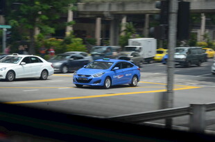 城市道路上的蓝色轿车