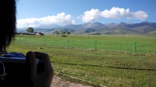 田野边的摄影者与远山