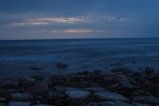 海边暮色下的礁石与海浪