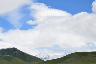 蓝天白云下的翠绿山峦