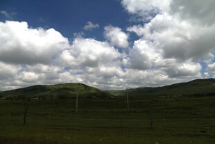 蓝天白云下的翠绿山峦