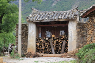 古朴乡村小屋前的柴垛