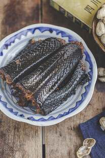蓝白瓷盘装的美味熏鳗鱼