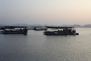 黄昏下的江面上停泊着船只