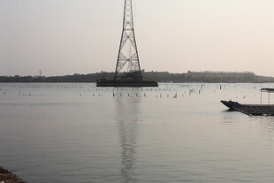 湛江河畔高塔与小船的景致