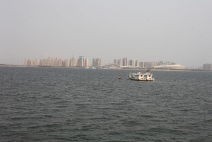 湛江海上小船与城市远景